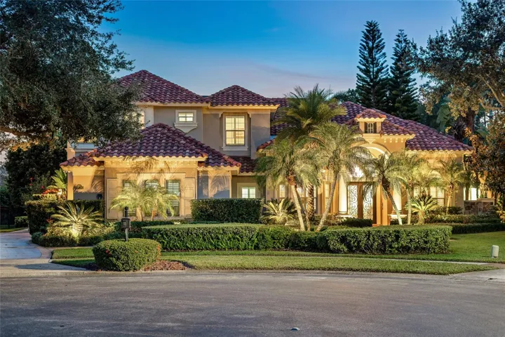 Twilight ExteriorDramatic twilight view highlighting refined architectural details, lush landscaping, and warm interior illumination.
