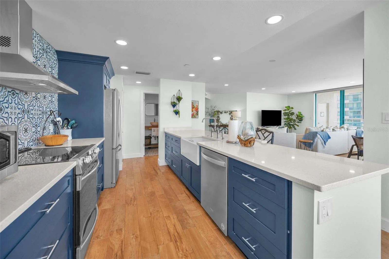 Cucina Features Versay Grand Blue Encaustic Style Porcelain Tile Backsplash, Stainless appliances, Quartz Counter Surfaces, Custom Shaker Style Cabinetry, Farmhouse Apron Front Sink &amp; more.