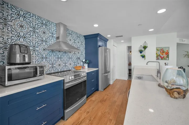 Cucina Features Versay Grand Blue Encaustic Style Porcelain Tile Backsplash, Stainless appliances, Quartz Counter Surfaces, Custom Shaker Style Cabinetry, Farmhouse Apron Front Sink & more.