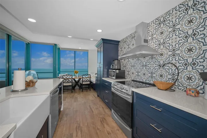 Cucina Features Versay Grand Blue Encaustic Style Porcelain Tile Backsplash, Stainless appliances, Quartz Counter Surfaces, Custom Shaker Style Cabinetry, Farmhouse Apron Front Sink & more.