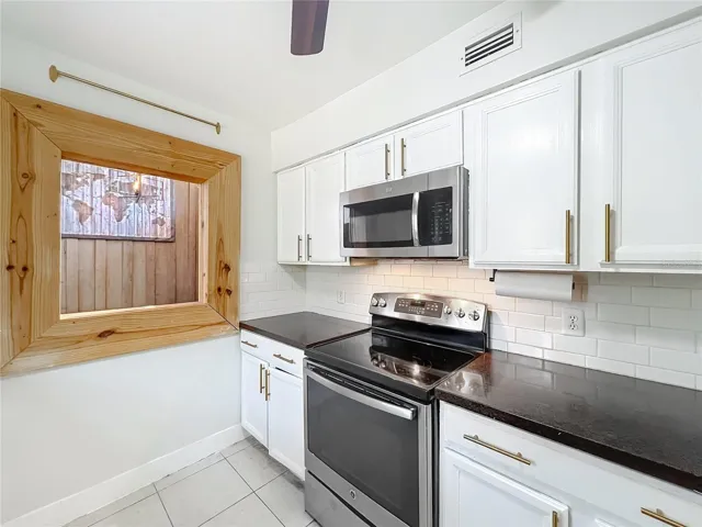 Kitchen with stainless steel appliances and granite counter tops.