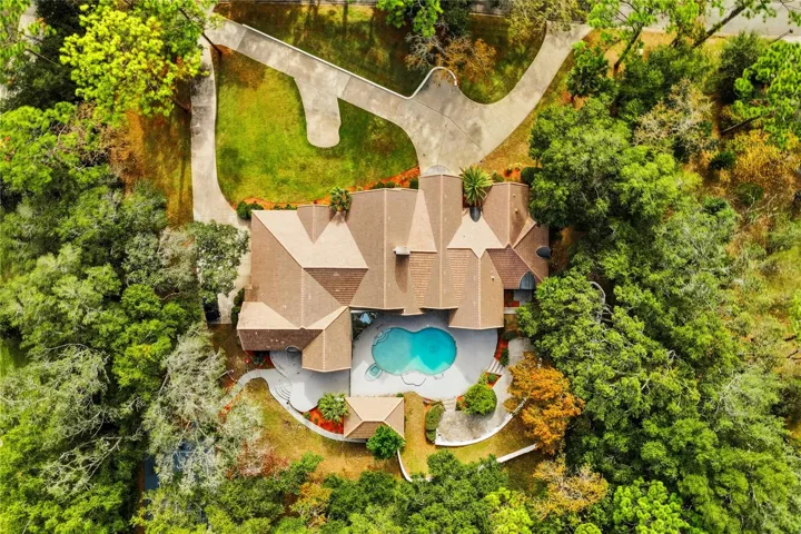Aerial of home and showcasing the pool.