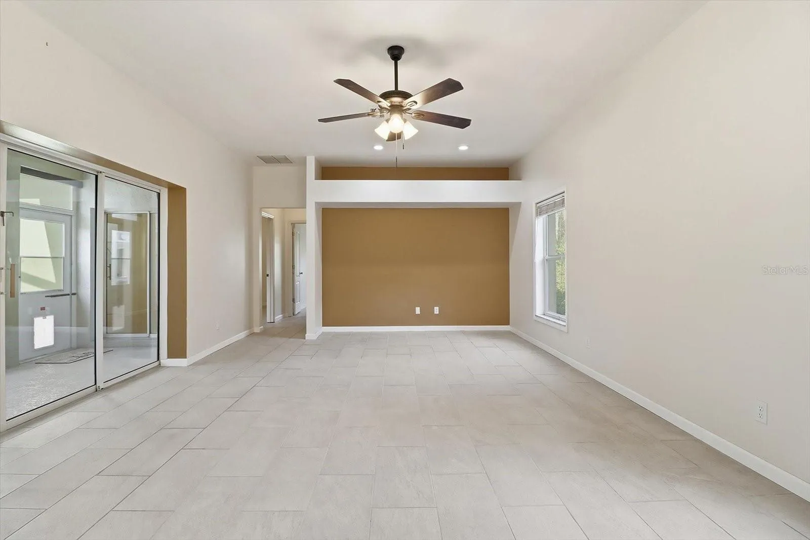 Living Room w/ Full Wall of Pocket Sliders that Open to the Sunroom & Screened Atrium