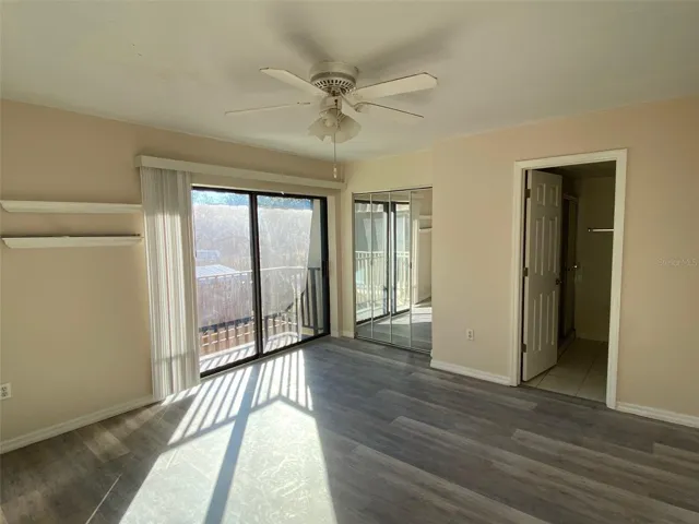 Mirrored walk in closet, NEW luxe vinyl flooring, private bath, balcony with view of private courtyard