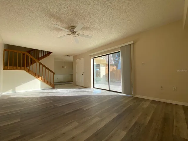 Sliding glass doors with new blinds from living room to courtyard