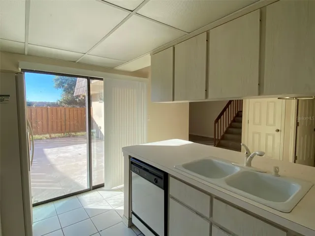 Sliding glass doors and new blinds from kitchen to courtyard
