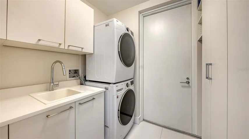 laundry room with cabinets for storage