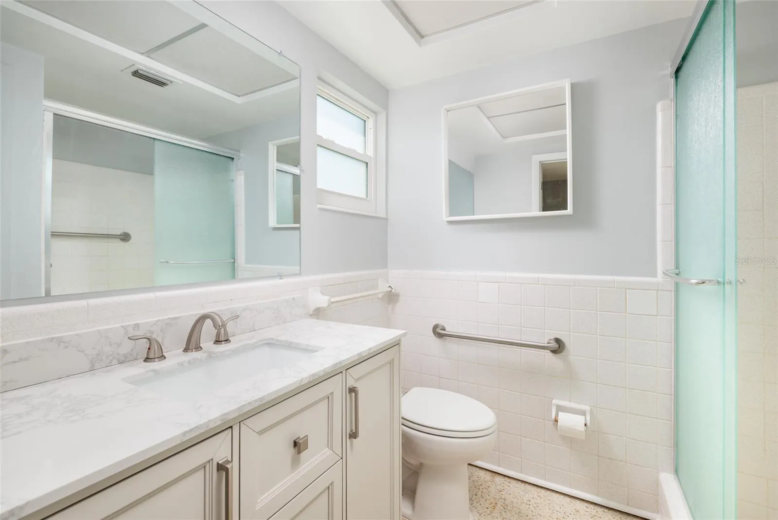 Primary bathroom w/Shower &amp; linen closet. Granite counter. Hurricane impact double pane window.