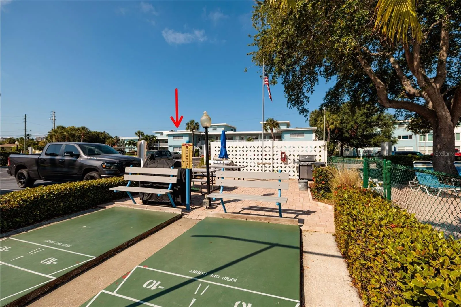 Grilling area 1 w/shuffleboard courts &amp; pool across street from the unit.