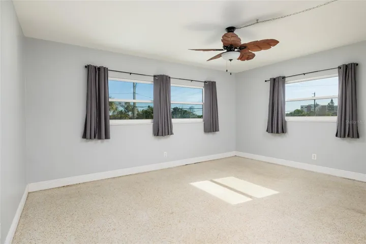 Front primary bedroom (16'x12') w/Hurricane impact double pane windows. Split bedrooms. En-suite bathroom & walk-in closet.