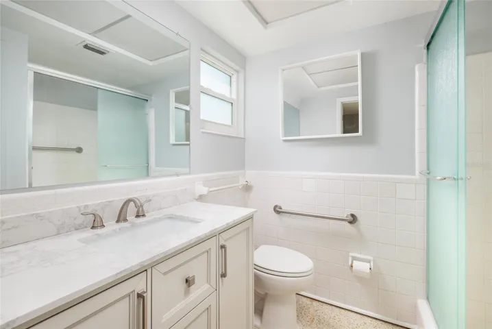Primary bathroom w/Shower & linen closet. Granite counter. Hurricane impact double pane window.