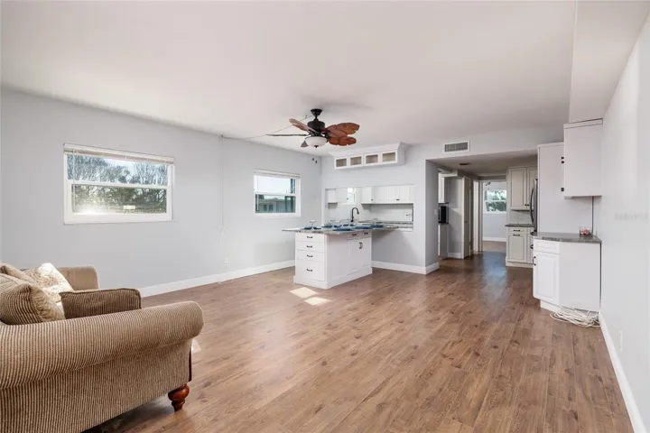 Living/Dining areas (16'x19'). Laminate flooring. Large pass through to kitchen.