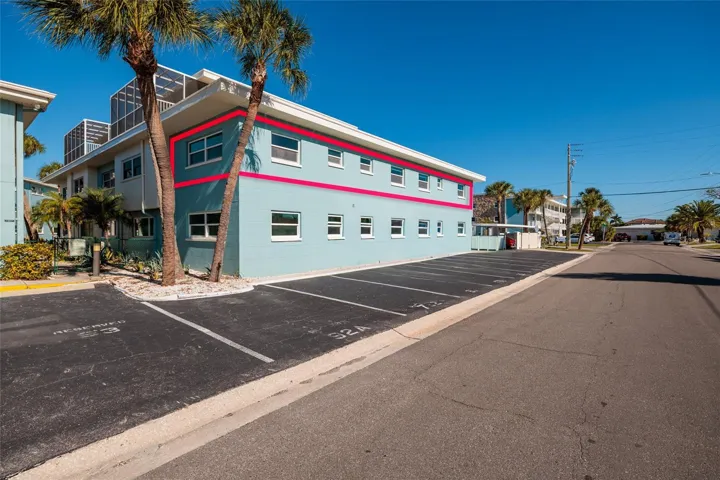 Corner top floor unit w/Hurricane impact double pane windows. There is additional guest parking on this side of bldg.