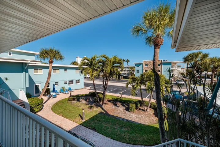 View from walkway/ porch outside of front door. Laundry/storage room is downstairs & straight down the walkway.