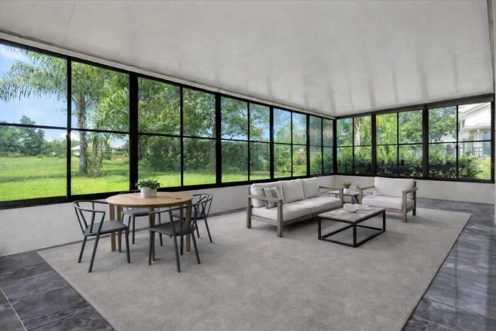 Oversized lanai offers a bright, breezy outdoor living space with panoramic views—perfect for dining, lounging, and entertaining year-round. Furniture staged.