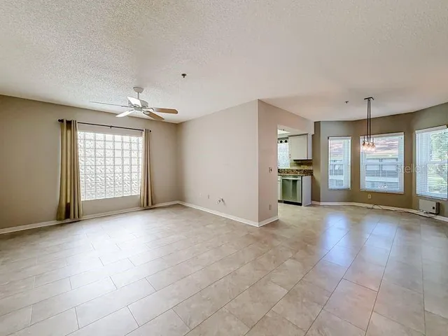 Spacious living room looking into dining area and kitchen