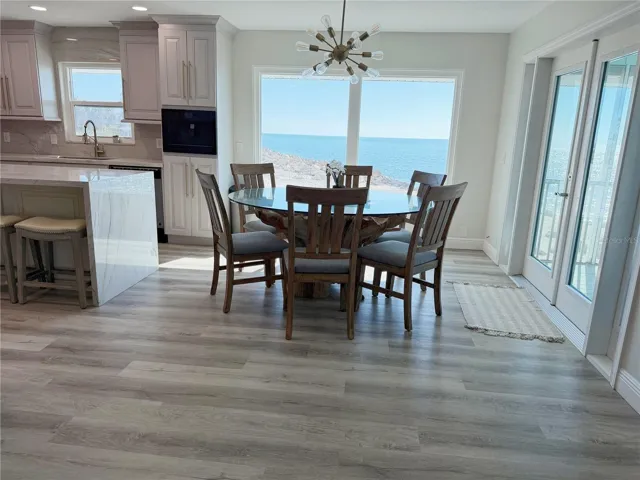Dining area and kitchen with Gulf views and open floor plan.