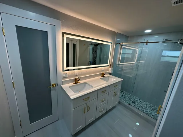 Primary ensuite bathroom - view 1 (note the lighted mirror).