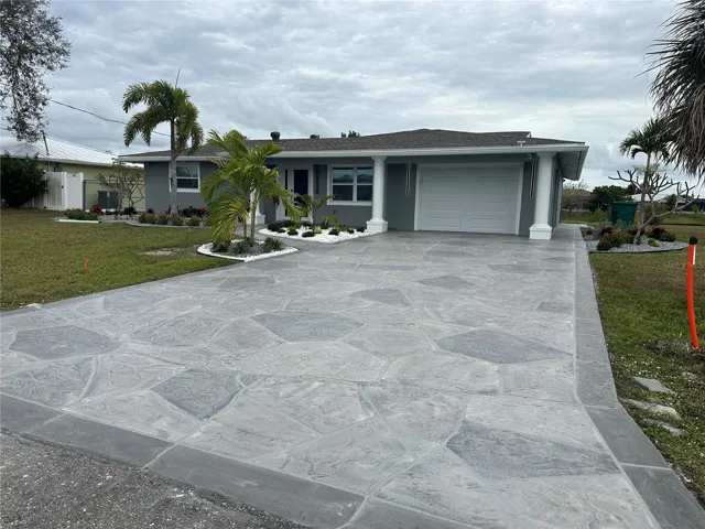 Decorator driveway, upgraded landscape beds, and new paint = great curb appeal.