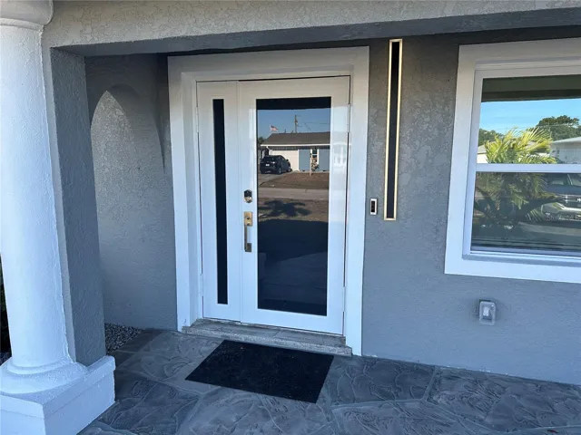 Electronic door lock on a frosted glass door.