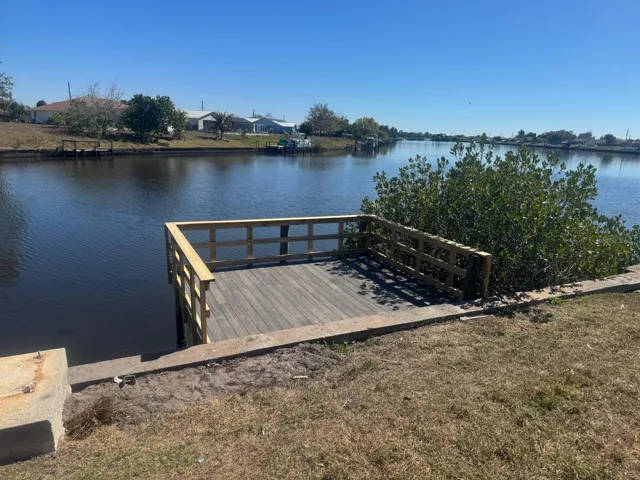 Dock, seawall, and wide water view of the canal.