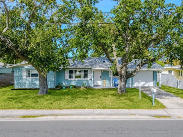 Charming single-story ideally located, Seminole home showcases a welcoming curb appeal with mature shade trees, a spacious driveway, and an attached garage.