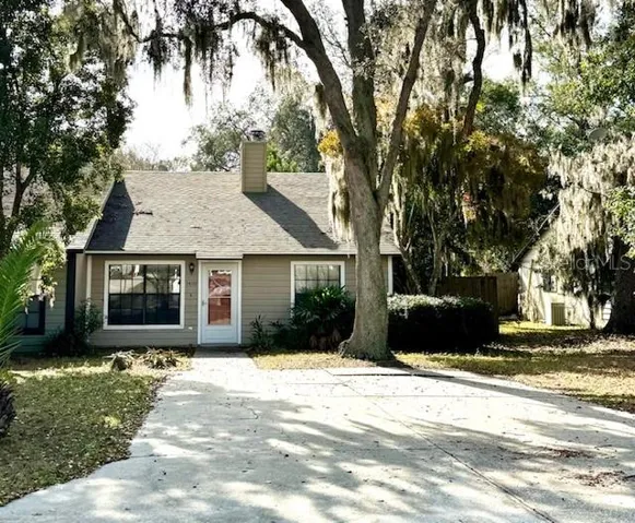 Exterior front with oversized concrete parking pad and driveway.