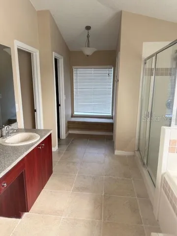 The primary bathroom features a cozy window seat.