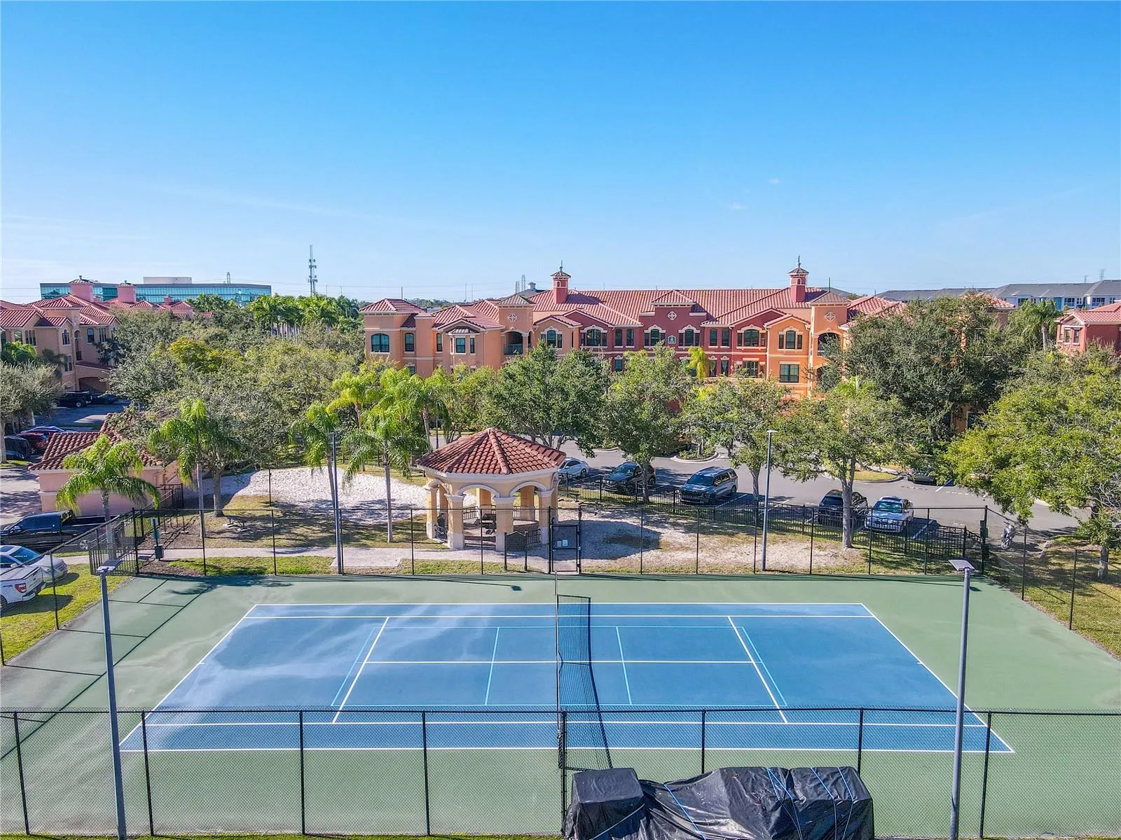 Aerial view of the beautifully maintained tennis court.