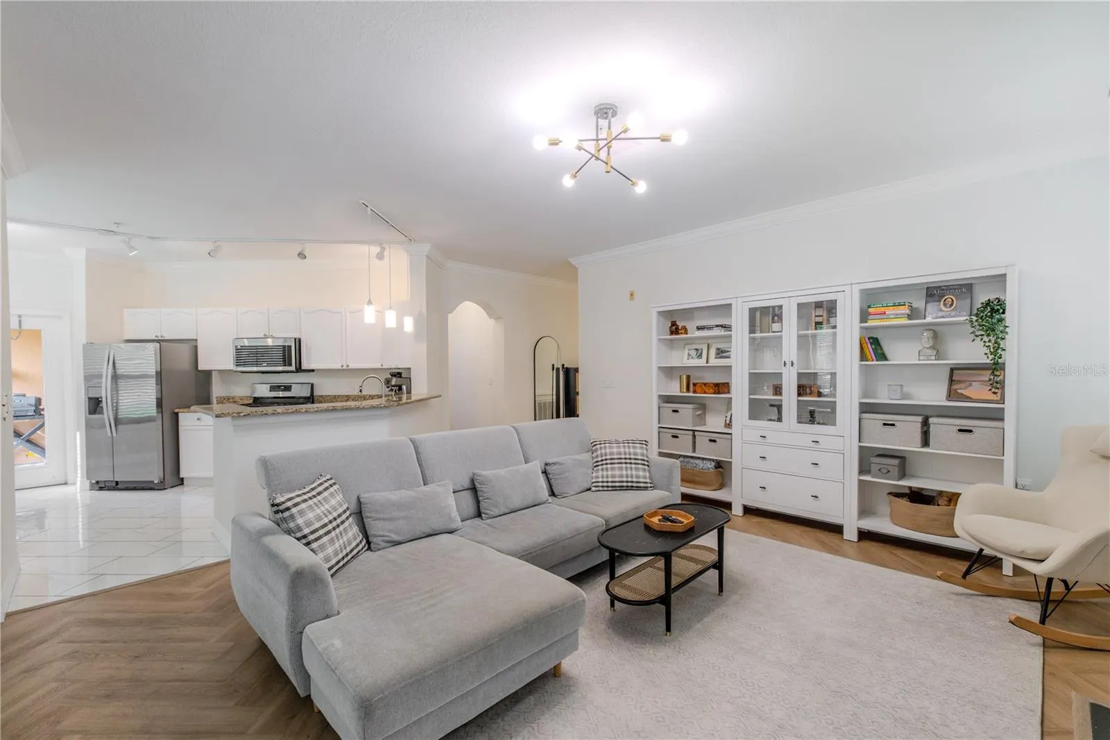 This view shows the open concept flow between the living room and kitchen areas.