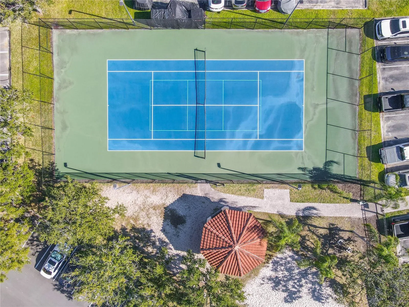 Another aerial view of the beautifully maintained tennis court.