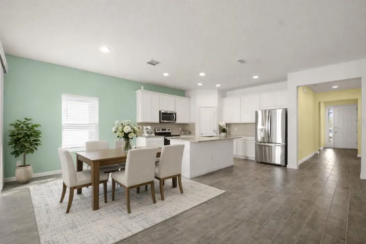 This photo has been virtually staged. Kitchen and Dining room view from Living Room.