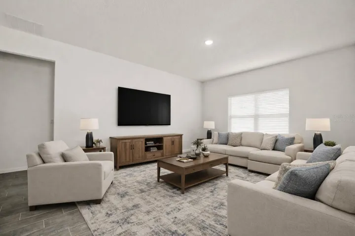 This photo has been virtually staged. View of living room from dining area.