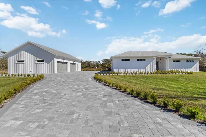A 5,000 SqFt paver driveway provides ample parking space, while the primary residence's oversized 19’ x 22’ (510 SqFt) garage and secondary residence's oversized 28’ x 38’ (1,152 SqFt) garage provide storage for 6+ vehicles