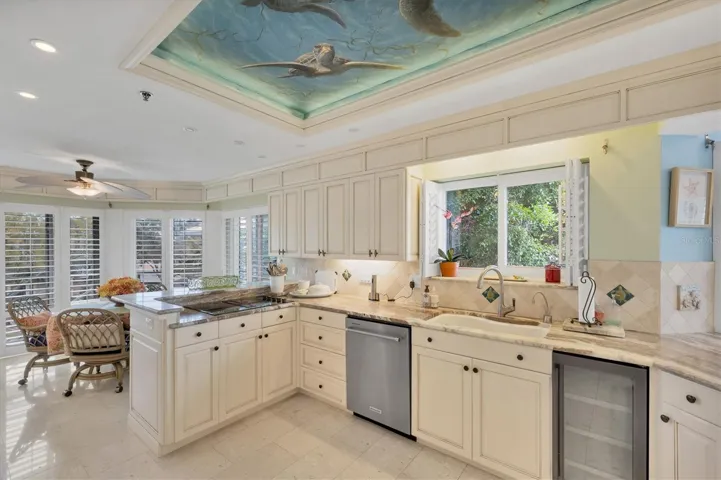 Kitchen has a Jenn Aire cooktop & wine refrigerator