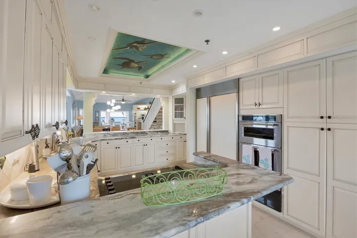 Enjoy the custom painted ceiling & abundant cabinetry