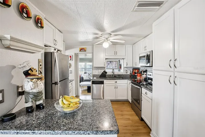 Kitchen showing granite countertops and storage.