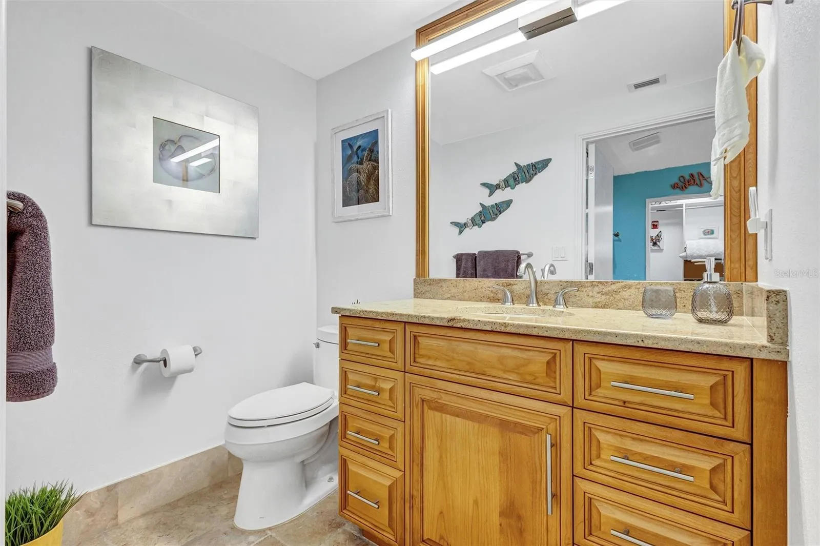 Oakwood primary bathroom With polished granite surfaces. Stainless steel steel turned handles And mirror