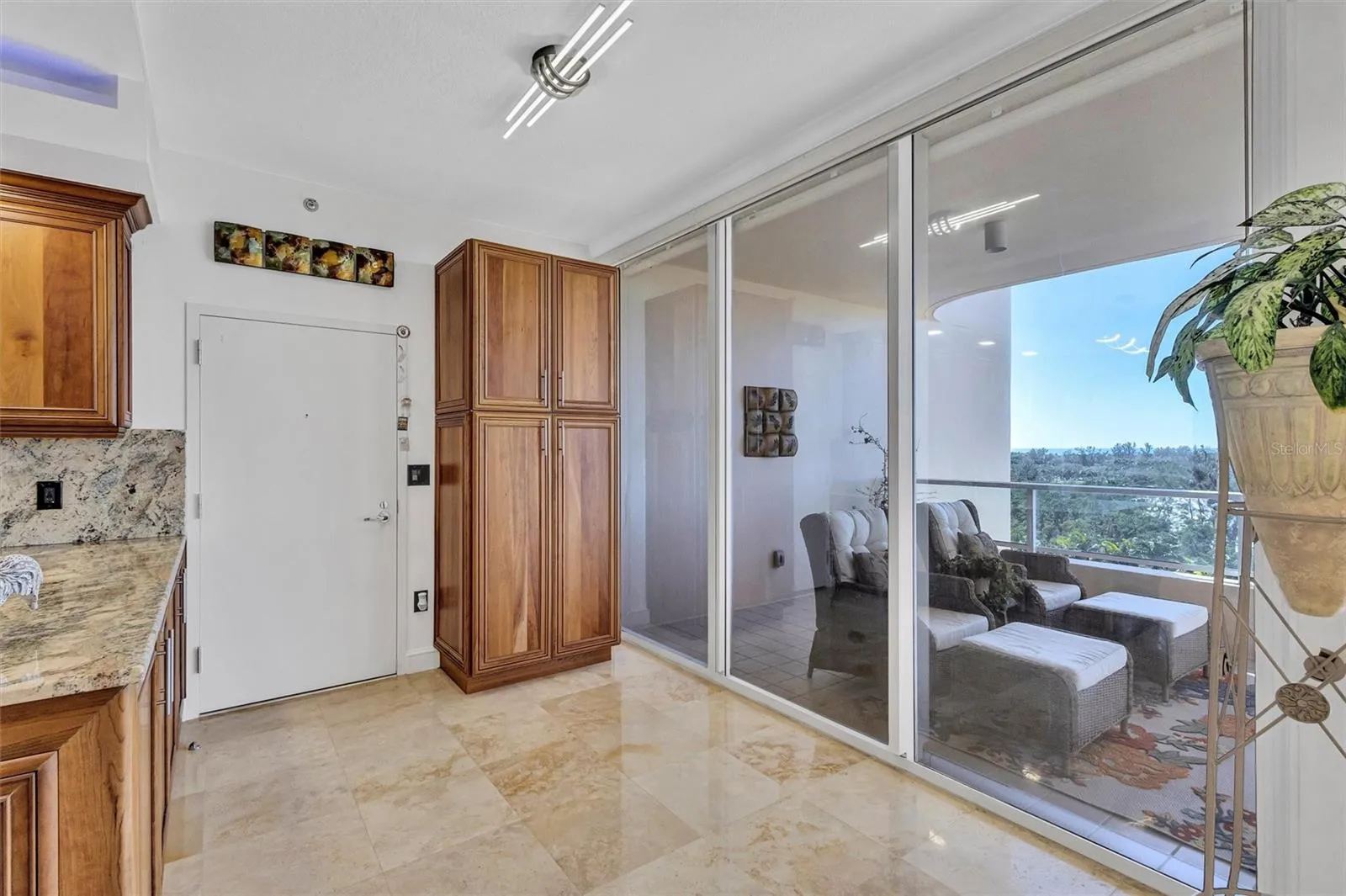 A large pantry with pullout drawers round out the kitchen cabinet tree. All very conveniently located with sliders to the front Terrace.