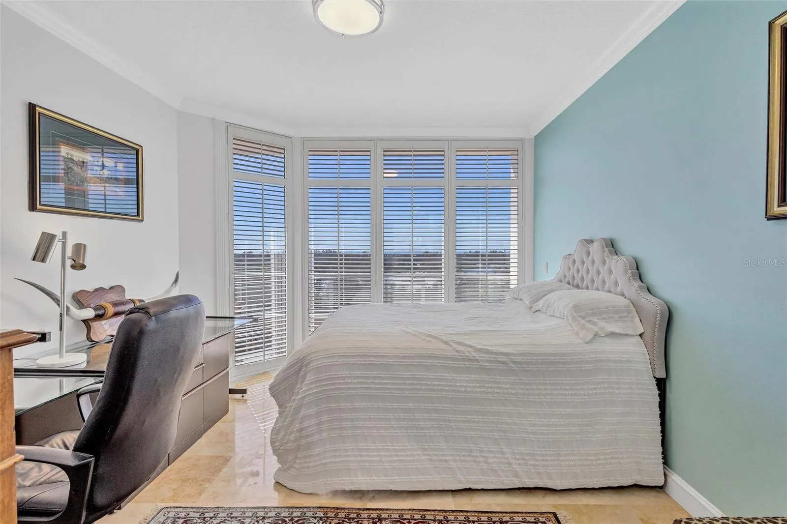 Residence Secondary or guest bedroom with floor, ceiling, windows, and plantation shutters crown, moldings, and modern lighting