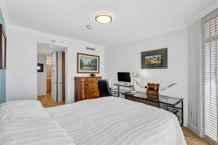 Residence Secondary / Guest Bedroom with access to the Westerly Balcony.  Large Closet, with Large Walk in Shower, Storage and Bathroom. Travertine Floors and Functioning Shutters