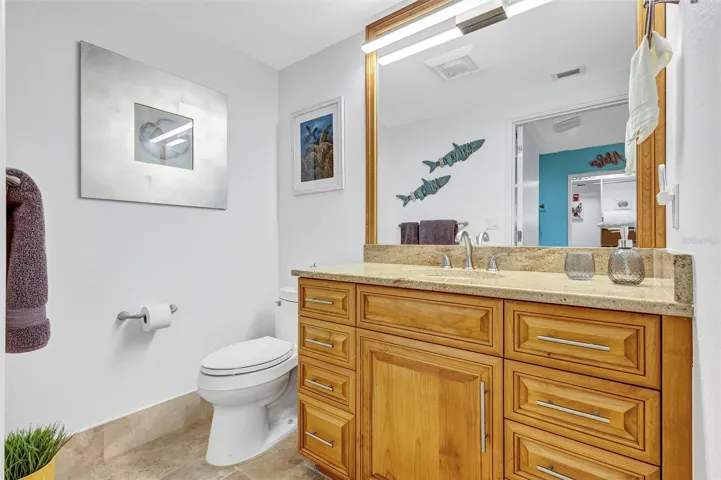 Oakwood primary bathroom With polished granite surfaces. Stainless steel steel turned handles And mirror