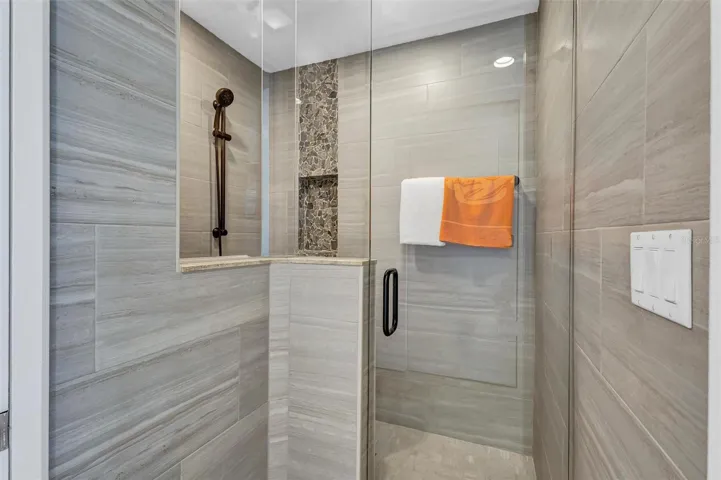 Residence Secondary / Guest Bedroom with  large glass  shower. Unit has access to the Westerly Balcony.  Large Closet, with Large Walk in Shower, Storage and Bathroom. Travertine Floors