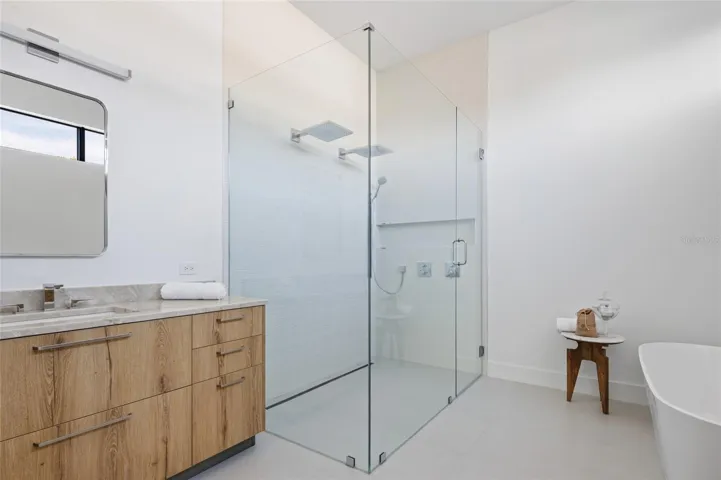 Spa-style shower &amp; quartzite vanity in primary bath