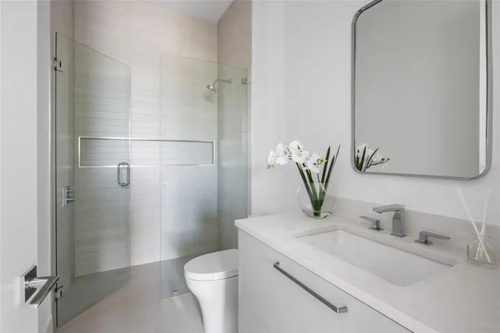 Downstairs full bathroom with Italian cabinetry &amp; curb-less walk-in shower