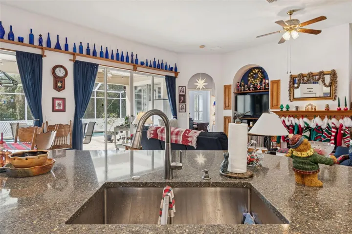 Undermount Sink in Large Kitchen Island Overlooking the Family Room