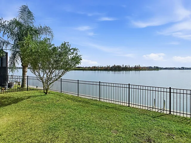Private backyard with wrought iron fencing—perfect for family and pets.