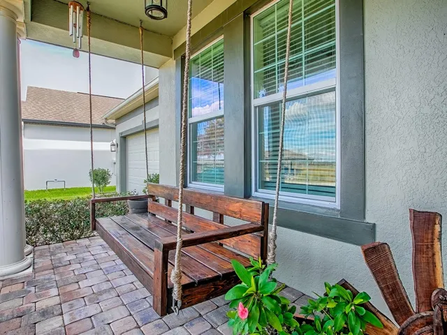 Covered Front Porch Offering Tranquil Canal and Conservation Views