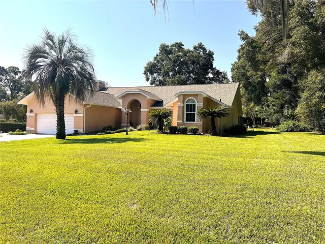 Magnificent home featuring three bedrooms and two and a half bathrooms, a large screen-enclosed lanai, and an in-ground pool. Nestled beautifully on over one-half acre in Lovely Country Club Estates.
