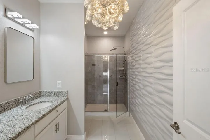 Main Suite with Applied Wall Detail, Custom Mirrors, Vanity Lights and Chandelier